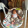 baby, infant, child, portrait, sitting, rocker, baby_seat, blanket, striped_onesie, clothing, face, eyes, hair, feet, indoors, living_room, chair, furniture, wood_floor, colorful_pattern