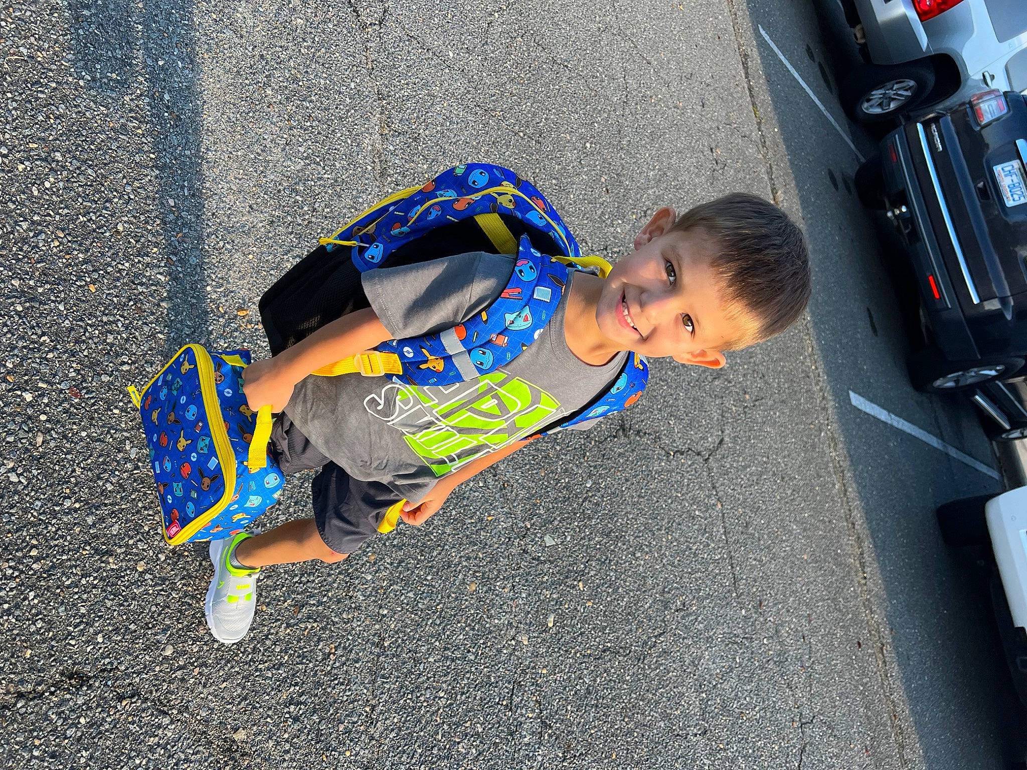 Jackson joined the competition — help win amazing prizes! asphalt, automotive_exterior, automotive_lighting, automotive_tail_brake_light, automotive_tire, bumper, electric_blue, fender, fun, joy, motor_vehicle, person, road, road_surface, sidewalk, street, t_shirt, tire, toddler, vehicle