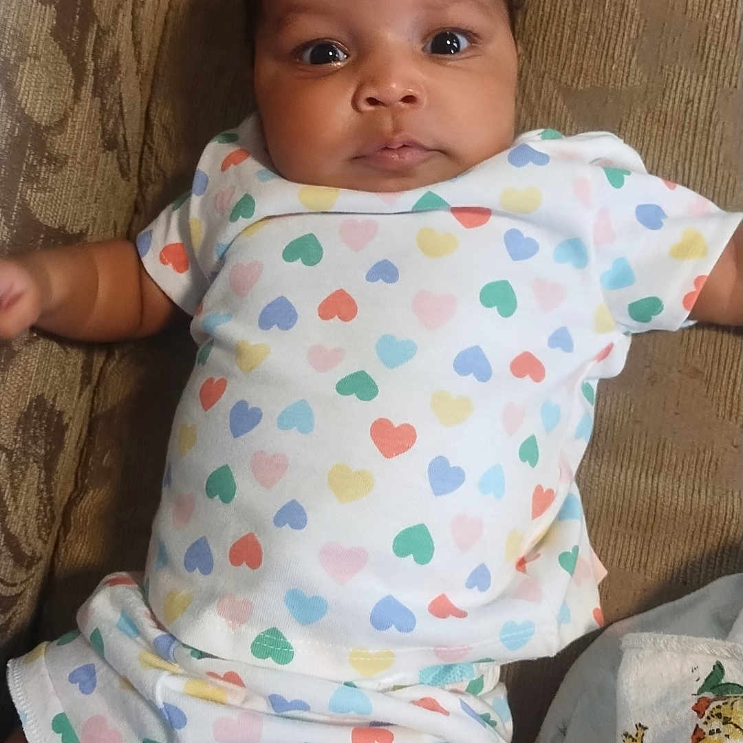 Rae'Anna joined the competition — help win amazing prizes! baby, bodypart, chair, clothing, couch, cushion, diaper, dress, face, finger, furniture, hand, head, homedecor, newborn, person, photography, portrait, sitting, t_shirt