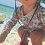toddler, child, beach, sand, sunhat, floral_clothing, closed_eyes, water, ocean, toys, sandy_legs, squatting, summer, vacation, sunlight, colorful, play, shoes, outdoor, nature
