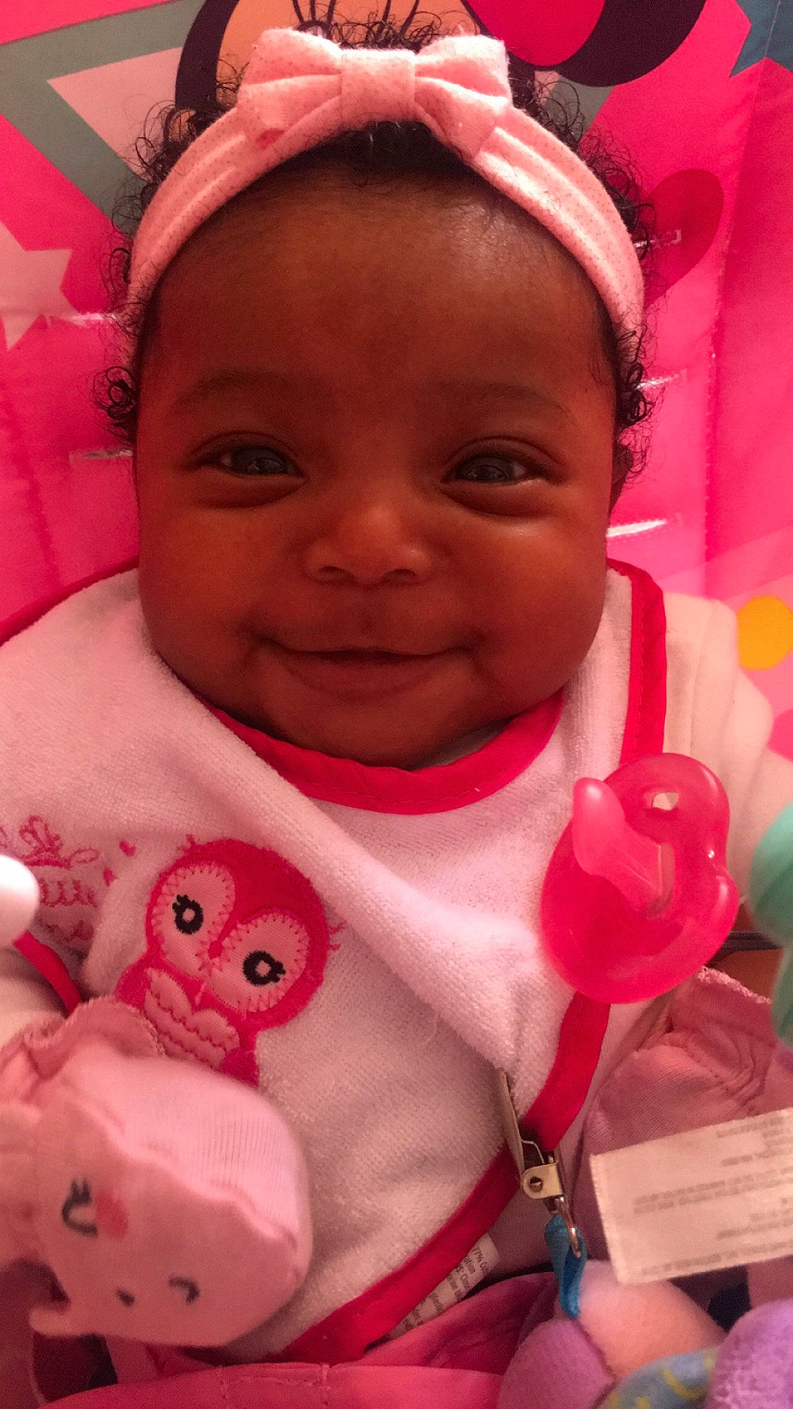 Nuri is registered to the contest to win money with this photo: baby, cheek, child, face, facial_expression, happy, head, lip, magenta, mouth, nose, person, pink, skin, smile, textile, toddler