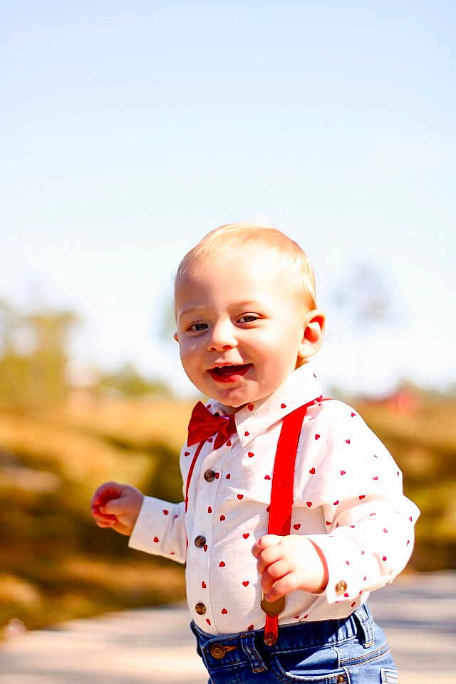 Cayden joined the competition — help win amazing prizes! toddler, child, boy, outdoor, sunny, shirt, red_suspender, bow_tie, smiling, walking, face, blond_hair, nature, daylight, cute, happy, jeans, portrait, casual, background_blur