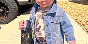 Savanna is registered to the contest to win money with this photo: accessory, boots, casual, child, clothing, cute, daytime, denim_jacket, denim_shorts, fashion, handbag, large_bow, outdoor, person, playful, portrait, sidewalk, small_child, sunny, toddler