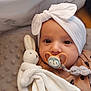 adorable, baby, blanket, brown_clothing, child, closeup, comfort, cuddly, cute, eyes, face, headband, indoors, infant, newborn, pacifier, plush_toy, rabbit, sleepy, soft_texture