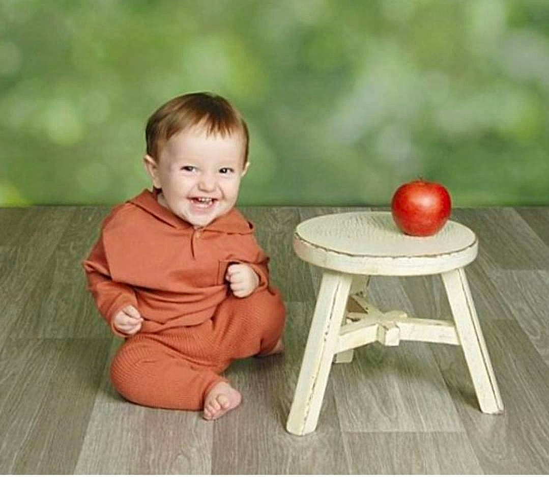 Chancley is registered to the contest to win money with this photo: baby, baby_toddler_clothing, chair, child, comfort, flooring, fun, grass, happy, hardwood, head, joy, leisure, outdoor_furniture, outdoor_table, person, sitting, smile, table, tableware