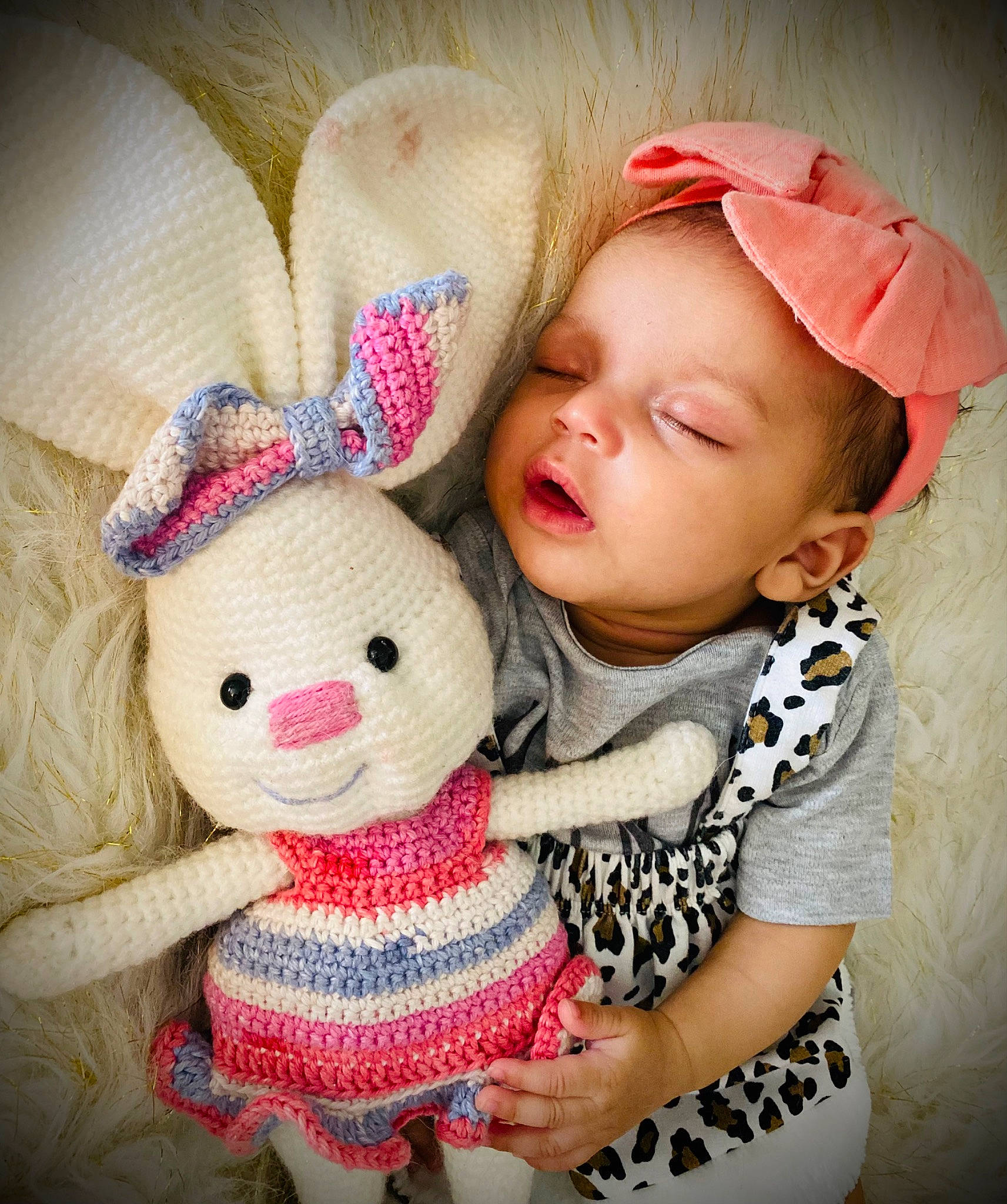 Kelani is registered to the contest to win money with this photo: baby, baby_toddler_clothing, cap, cheek, comfort, doll, eye, facial_expression, fawn, happy, head, headgear, human_body, iris, lip, outerwear, person, pink, skin, textile