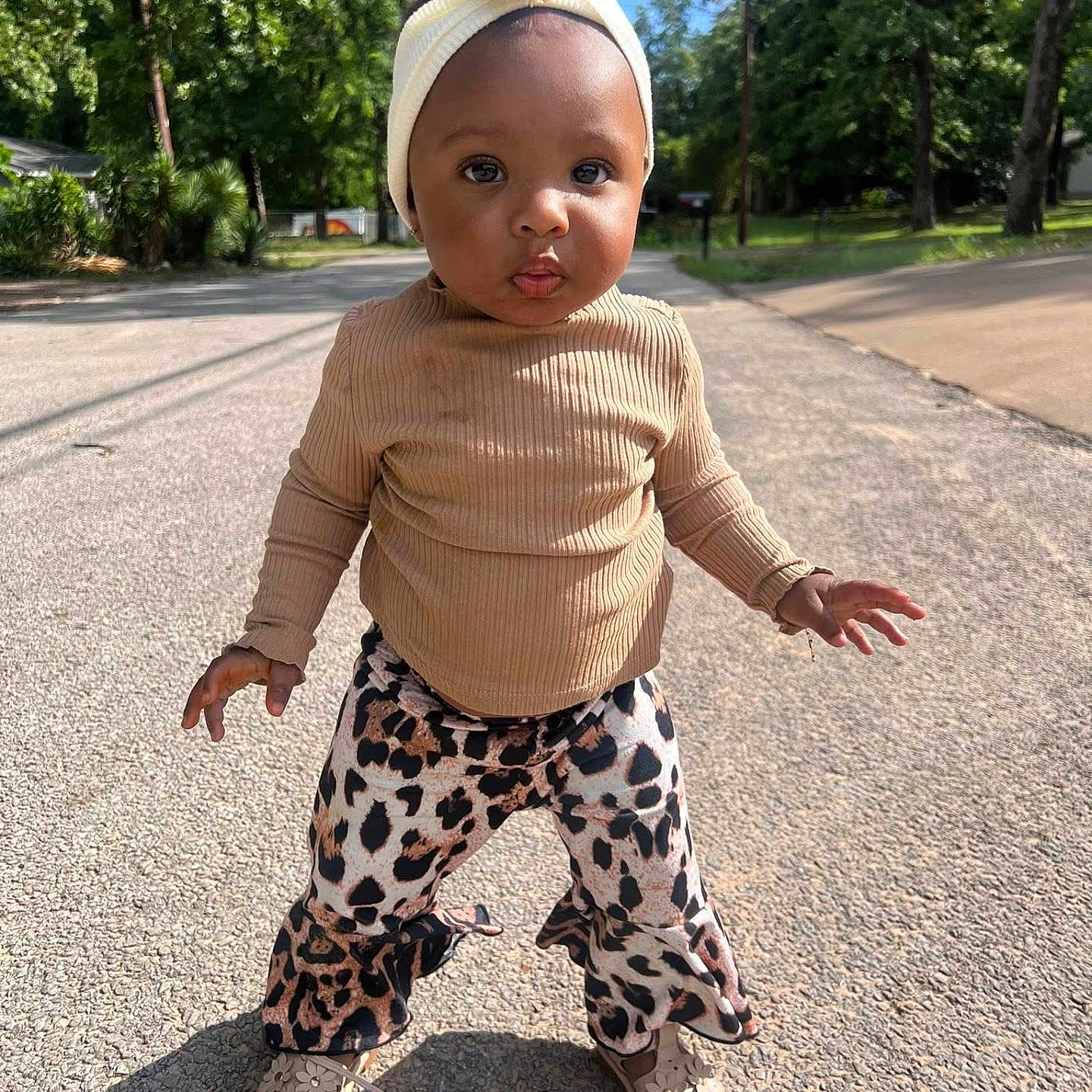 Layani is registered to the contest to win money with this photo: beige_top, child, confident, cute, daytime, fashion, headband, leopard_print_pants, nature, outdoor, person, portrait, shoes, sidewalk, street, sunlight, toddler, trees, walking, young_child