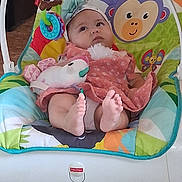 Arabella joined the competition — help win amazing prizes! baby, infant, child, fisher_price, baby_rocker, toys, plush_toy, colorful, headband, dress, feet, floor, indoor, face, expression, seat, comfort, animal_design, parrot_toy, monkey_design