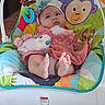 baby, infant, child, fisher_price, baby_rocker, toys, plush_toy, colorful, headband, dress, feet, floor, indoor, face, expression, seat, comfort, animal_design, parrot_toy, monkey_design
