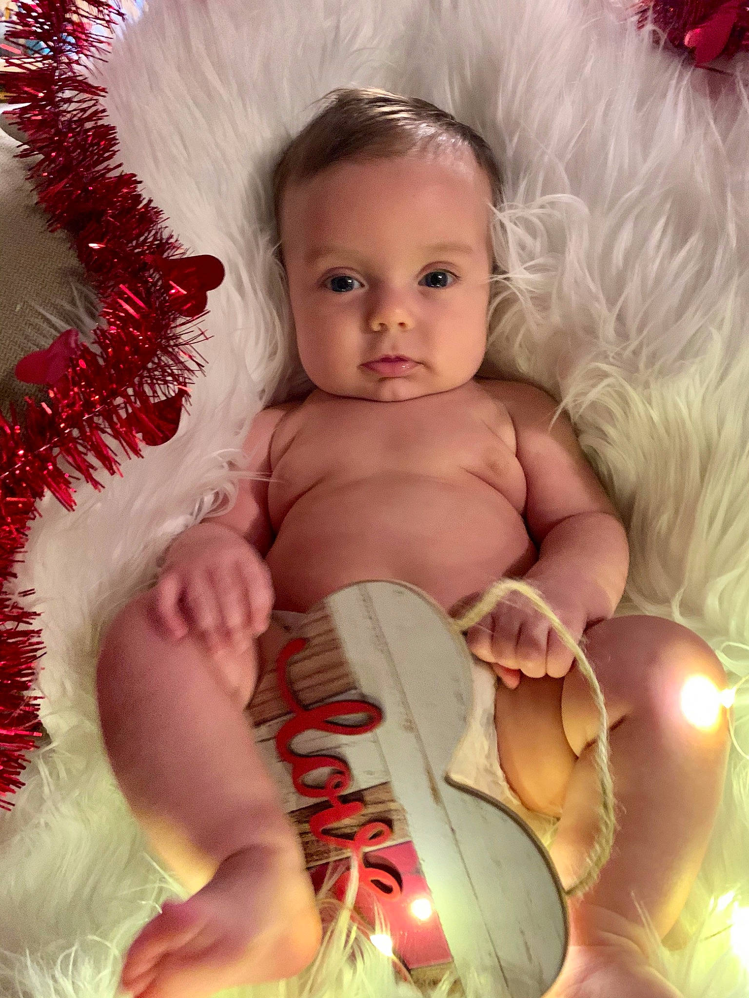 Benson is registered to the contest to win money with this photo: baby, baby_products, cheek, child, christmas, eye, fur, head, iris, leg, lip, mouth, muscle, person, photography, pink, product, red, skin, toddler