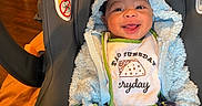 Cristian joined the competition — help win amazing prizes! baby, smiling, car_seat, bib, hoodie, blue, yellow, dinosaur_pants, indoor, child, happy, cute, infant, clothing, seatbelt, toy, holding, face, portrait, cozy