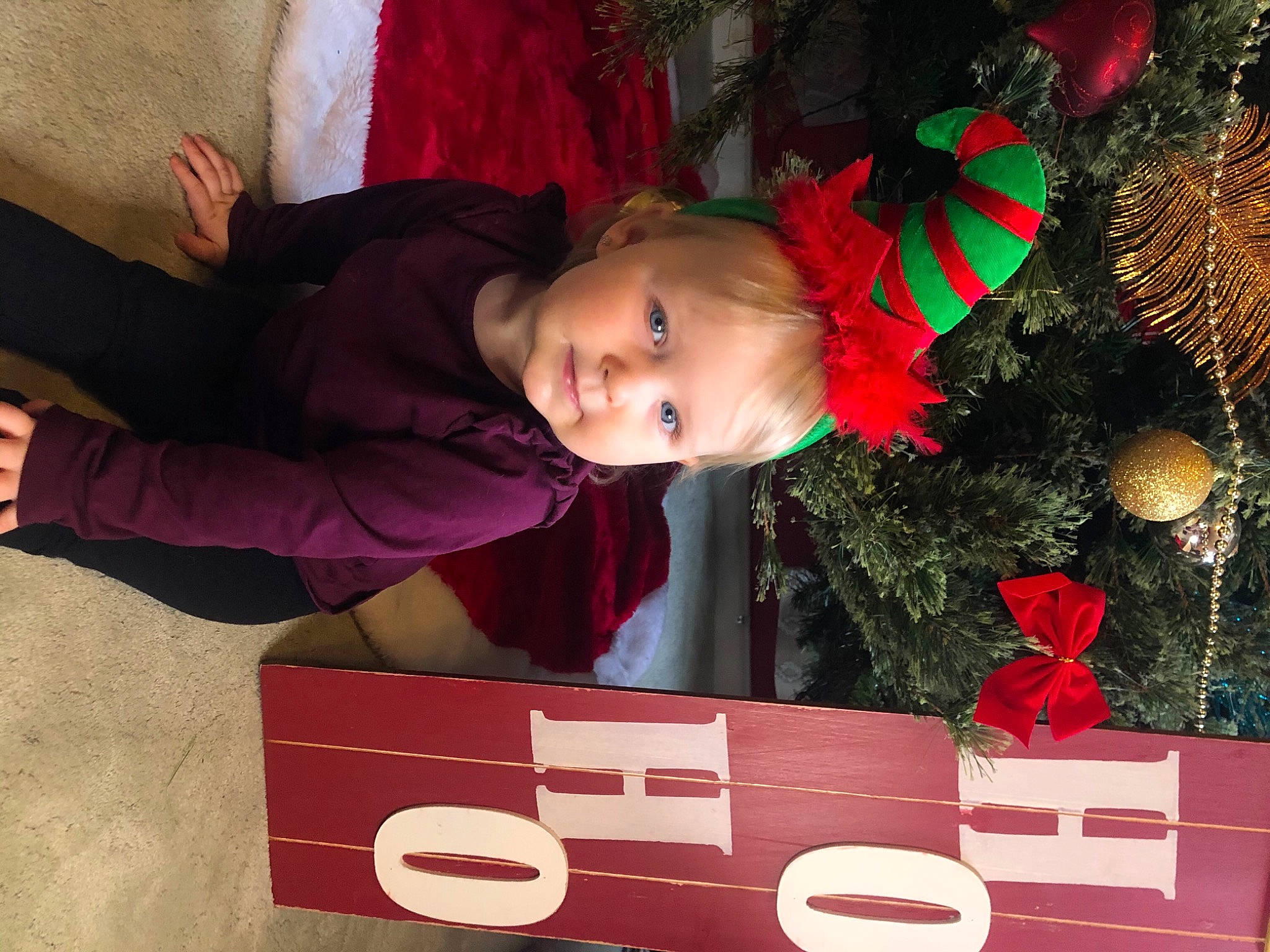 Arden is registered to the contest to win money with this photo: baby, baby_toddler_clothing, carmine, christmas, christmas_decoration, christmas_eve, christmas_ornament, christmas_tree, conifer, coquelicot, fir, holiday, holiday_ornament, human, number, ornament, person, pine_family, red, sign