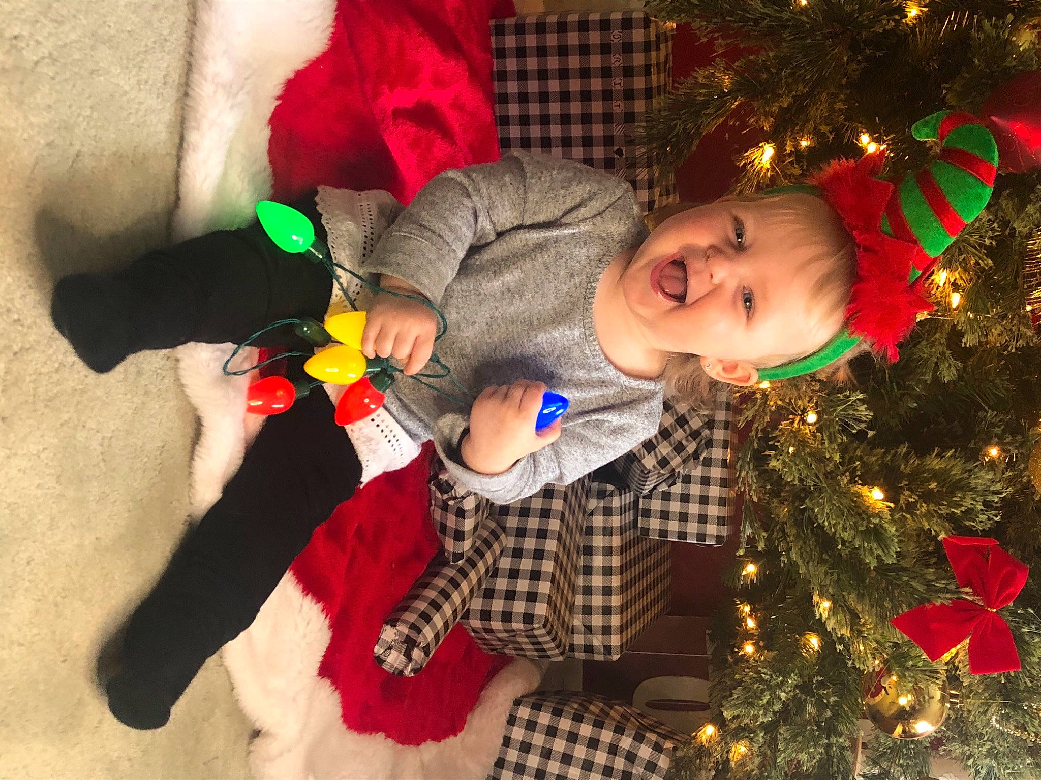 Arden joined the competition — help win amazing prizes! child, christmas, christmas_decoration, christmas_eve, christmas_lights, christmas_ornament, christmas_tree, costume_accessory, event, holiday, holiday_ornament, human, interior_design, person, plaid, plush, red, stuffed_toy, toddler, toy