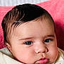 baby, closeup, face, infant, eyes, blanket, pink_background, skin, cheeks, eyelashes, mouth, nostrils, clothing, newborn, person, portrait, cute, soft, indoor, head