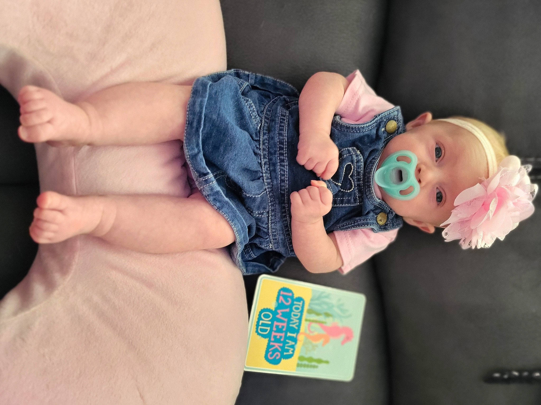 Elizabeth is registered to the contest to win money with this photo: baby, baby_products, baby_toddler_clothing, comfort, denim, doll, dress, finger, gesture, hand, headwear, human_body, joint, nail, person, pink, skin, sleeve, textile, toddler