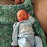 Easton joined the competition — help win amazing prizes! arm, baby, blanket, blue_clothing, couch, cozy, face, green, hand, indoor, infant, newborn, onesie, peaceful, person, relaxed, resting, sleeping, soft_texture, tattoo
