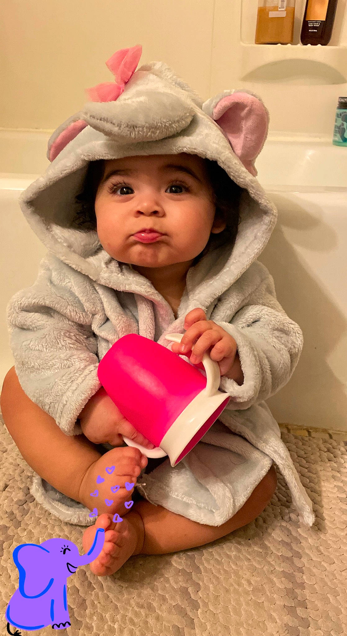 Sariah is registered to the contest to win money with this photo: baby, baby_playing_with_toys, baby_toddler_clothing, cap, cheek, child, eye, facial_expression, finger, fun, happy, headwear, lip, outerwear, person, pink, skin, sleeve, standing, toddler