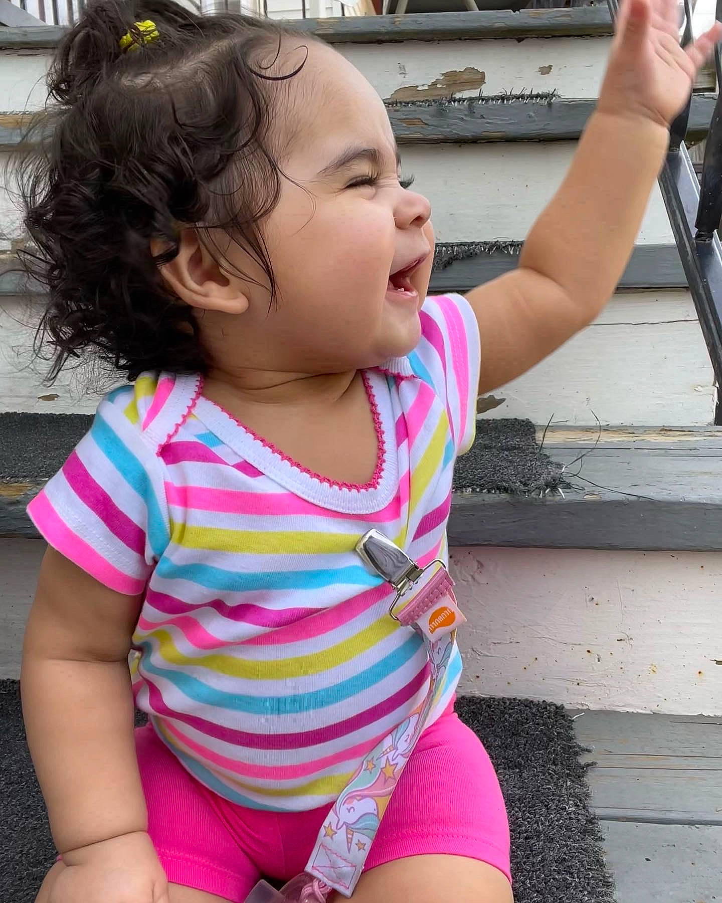Sariah is registered to the contest to win money with this photo: baby_toddler_clothing, chin, eye, hair, hairstyle, hand, happy, head, joint, leg, lip, mouth, neck, person, photograph, pink, shoulder, skin, sleeve, smile