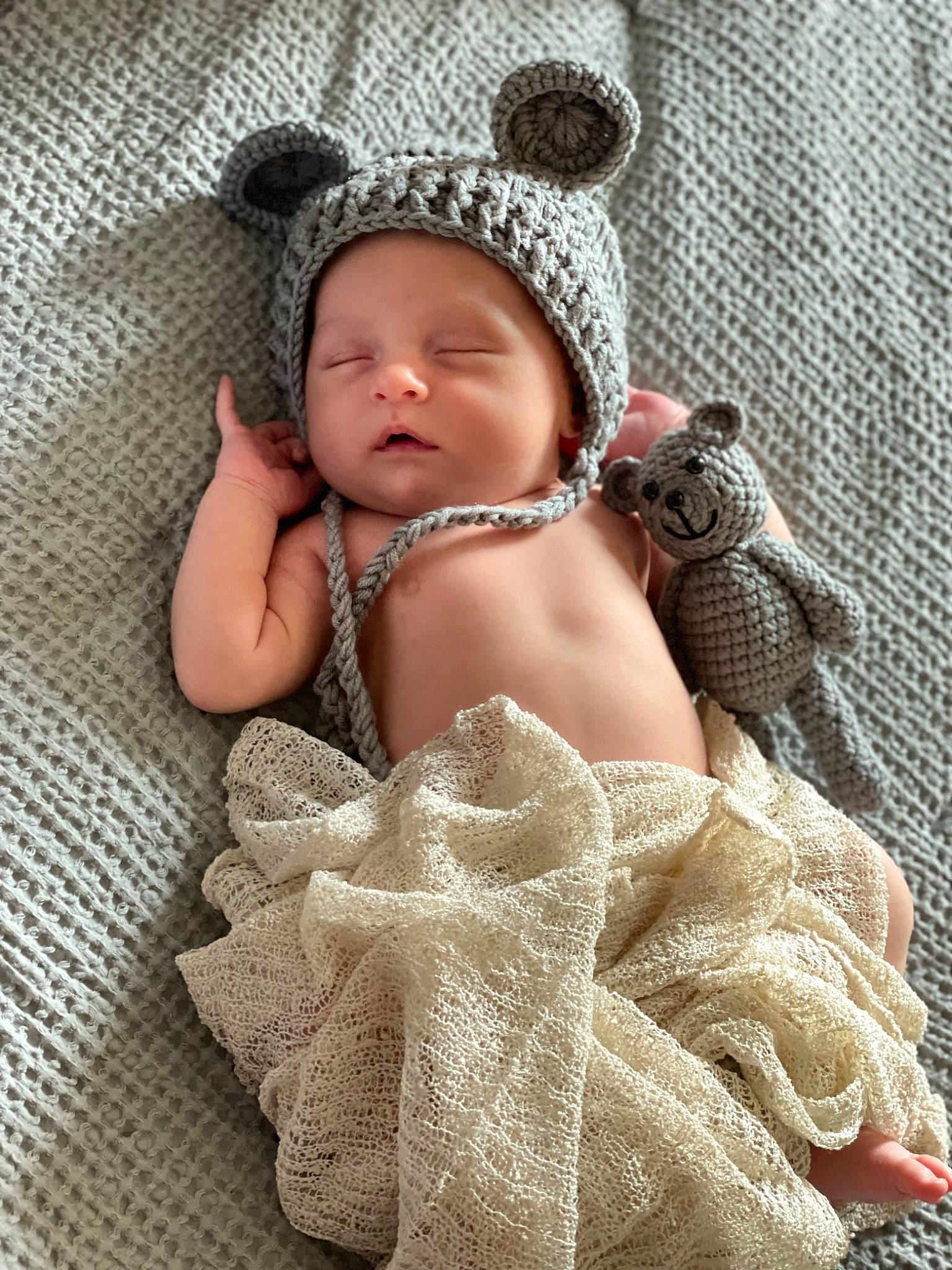 Dominic is registered to the contest to win money with this photo: baby, baby_products, baby_sleeping, baby_toddler_clothing, child, comfort, crochet, fashion_accessory, finger, fur, hand, headwear, knitting, linens, pattern, person, product, sitting, skin, textile