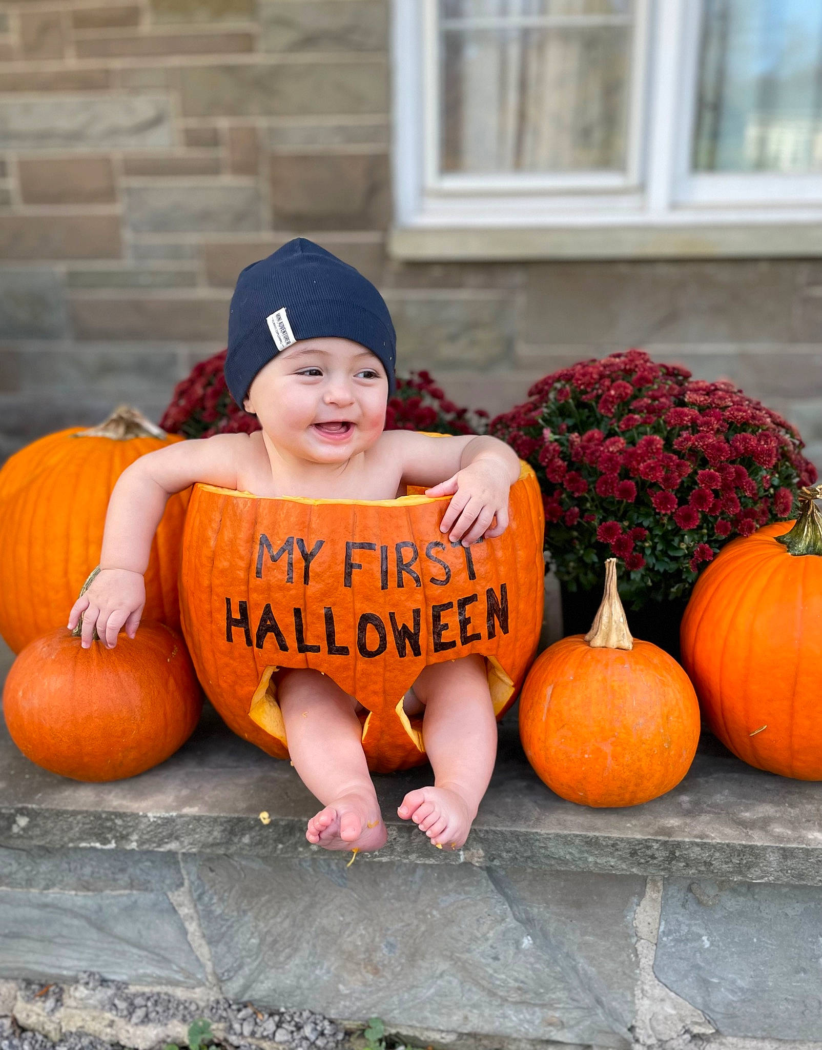 Dom is registered to the contest to win money with this photo: calabaza, cucurbita, facial_expression, gourd, grass, happy, headwear, local_food, natural_foods, orange, people, person, plant, pumpkin, sitting, smile, squash, vegetable, whole_food, window