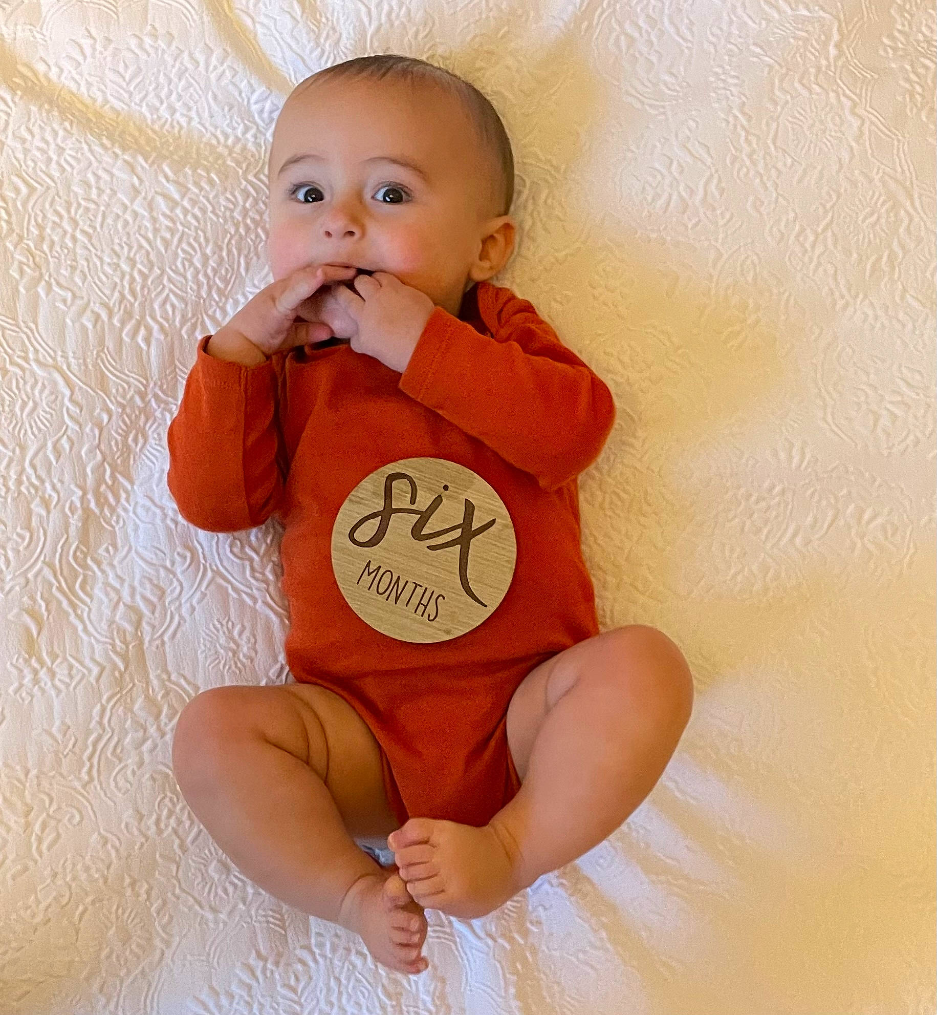 Dom is registered to the contest to win money with this photo: arm, baby, baby_toddler_clothing, cheek, comfort, eye, finger, gesture, hand, happy, head, human_body, joint, neck, person, skin, sleeve, stomach, t_shirt, thumb