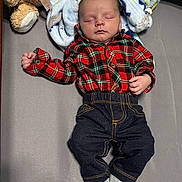 Colter joined the competition — help win amazing prizes! baby, infant, newborn, sleeping, plaid_shirt, flannel_shirt, jeans, socks, blanket, teddy_bear, soft_toy, crib, bedding, lying_down, peaceful, portrait, face, hands, nursery, cozy