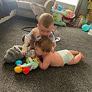 Kyle And Noah is registered to the contest to win money with this photo: baby, toddler, carpet, toy, diaper, living_room, sofa, child, play, floor, cute, home, furniture, stuffed_toy, window, curtain, birthday, balloon, childcare, carpeted_floor