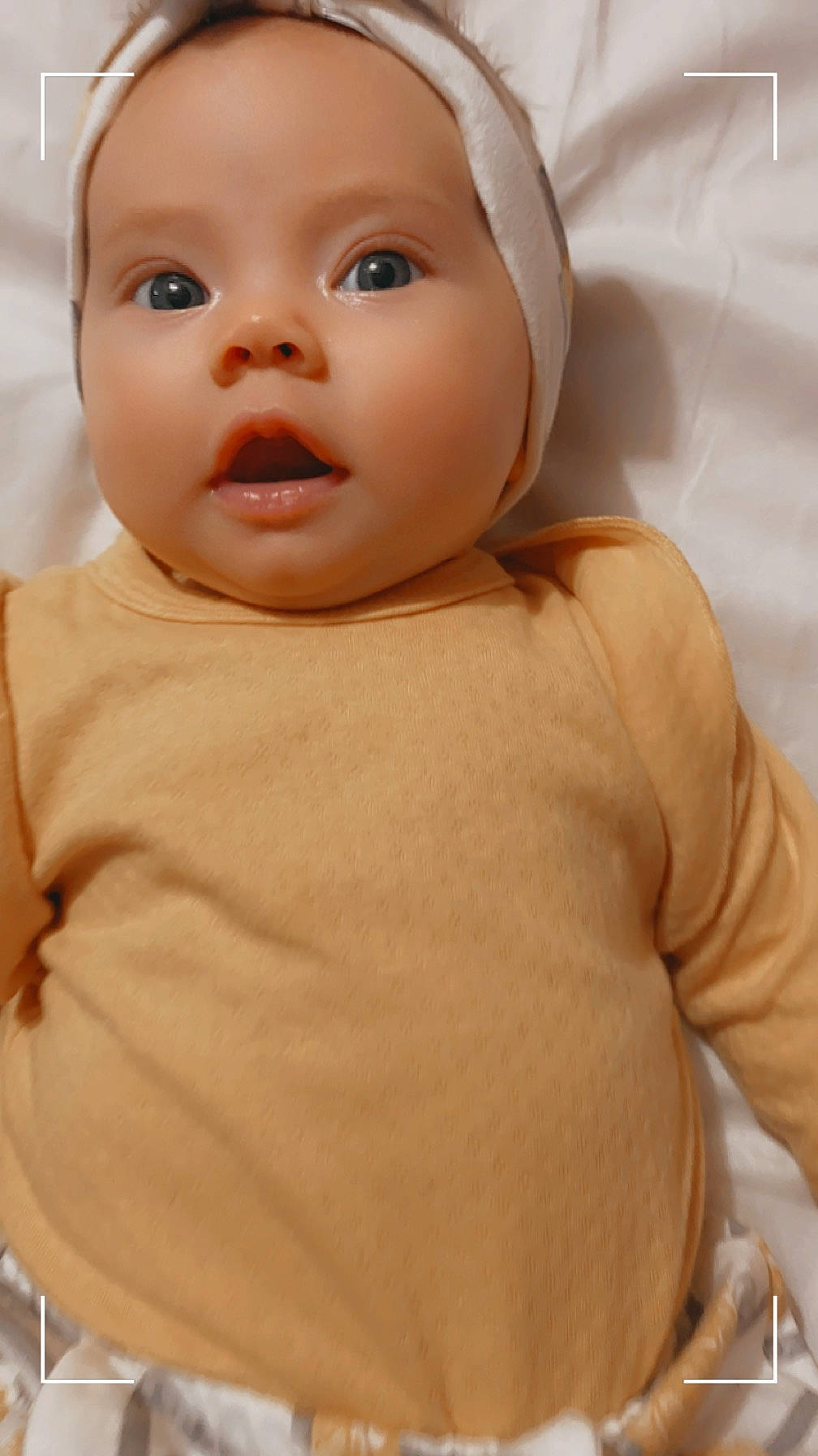 Elaina is registered to the contest to win money with this photo: baby, baby_toddler_clothing, cheek, child, chin, comfort, eyebrow, eyelash, happy, iris, linens, lip, no_expression, nose, peach, person, portrait_photography, skin, sleeve, toddler