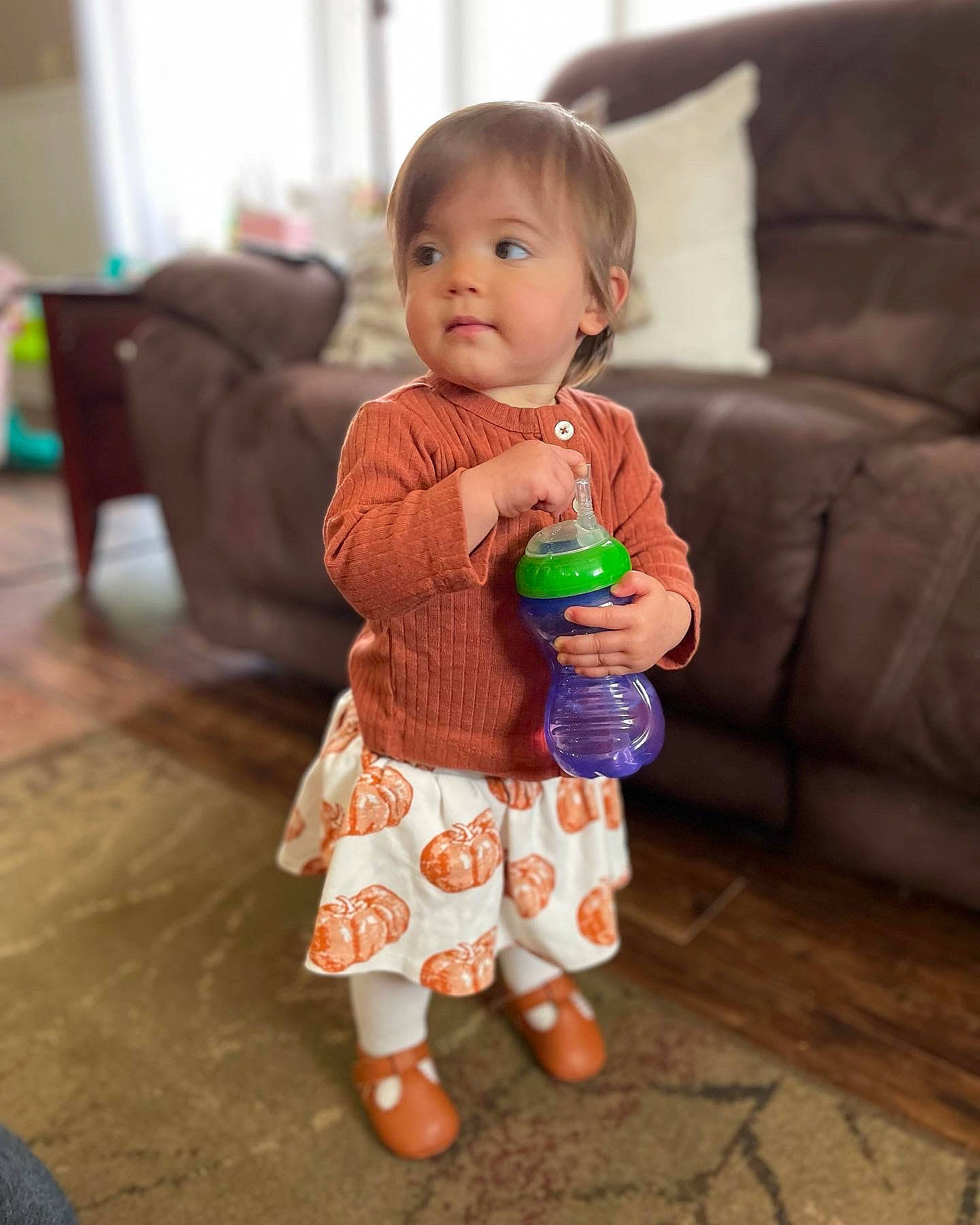 Ariella is registered to the contest to win money with this photo: baby, baby_toddler_clothing, cheek, child, comfort, couch, face, floor, flooring, fun, hand, happy, hardwood, head, human_body, person, sitting, skin, sleeve, toddler