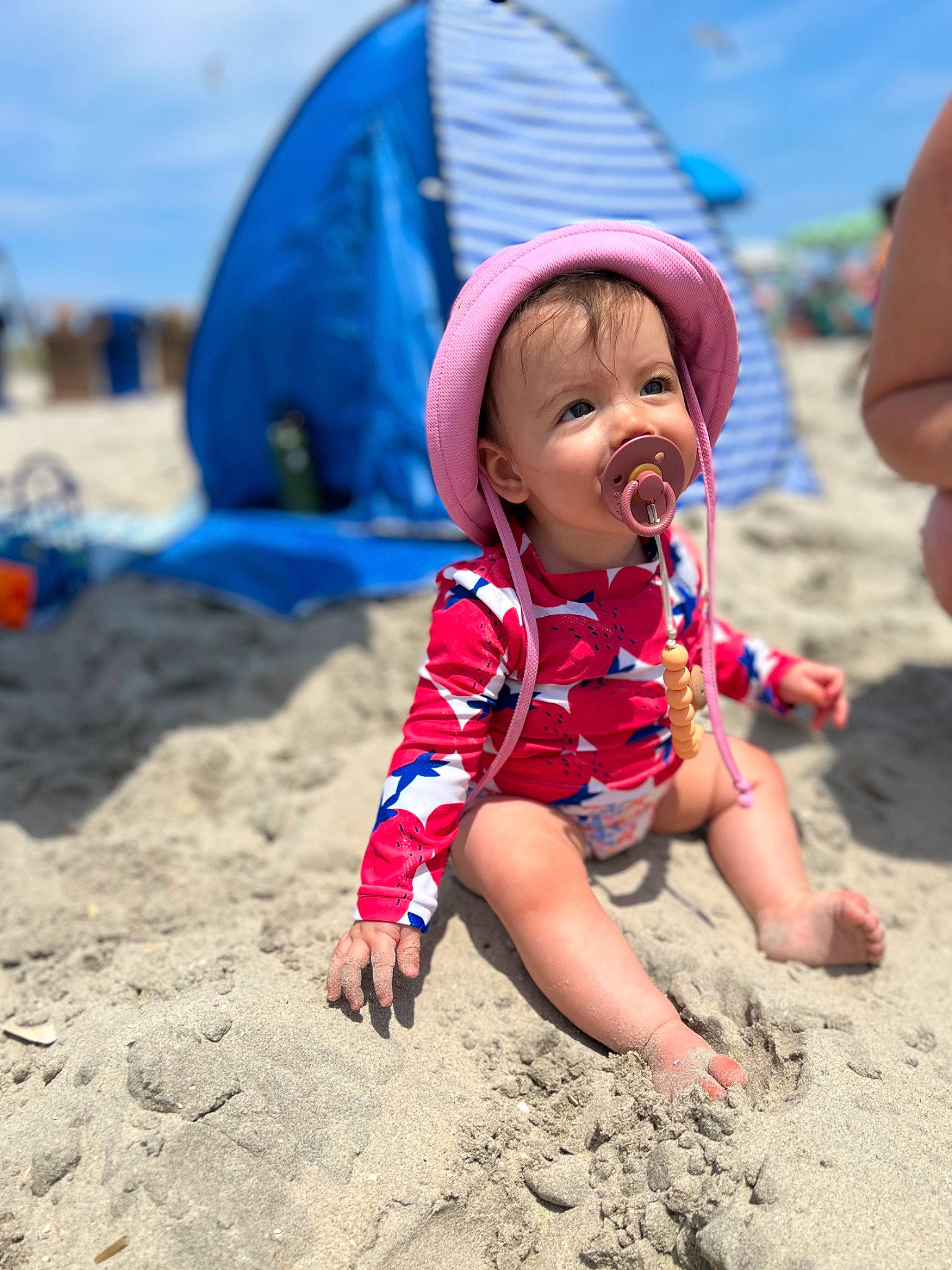 Ariella joined the competition — help win amazing prizes! barefoot, beach, blue, body_of_water, child, electric_blue, fun, happy, hat, leisure, people_on_beach, person, play, recreation, sand, sky, smile, soil, sun_hat, toddler