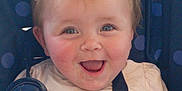 Kaydence is registered to the contest to win money with this photo: baby, child, smiling, face, car_seat, rainbow, cat_ears, hair_tie, blue_eyes, happy, clothing, seatbelt, infant, cute, indoors, portrait, messy, cheeks, playful, fun