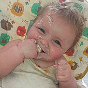 Kaydence is registered to the contest to win money with this photo: baby, messy, food, high_chair, blue_eyes, smiling, face, hands, cute, child, feeding, infant, clothing, colorful, animal_prints, happy, portrait, indoor, small_child, eating