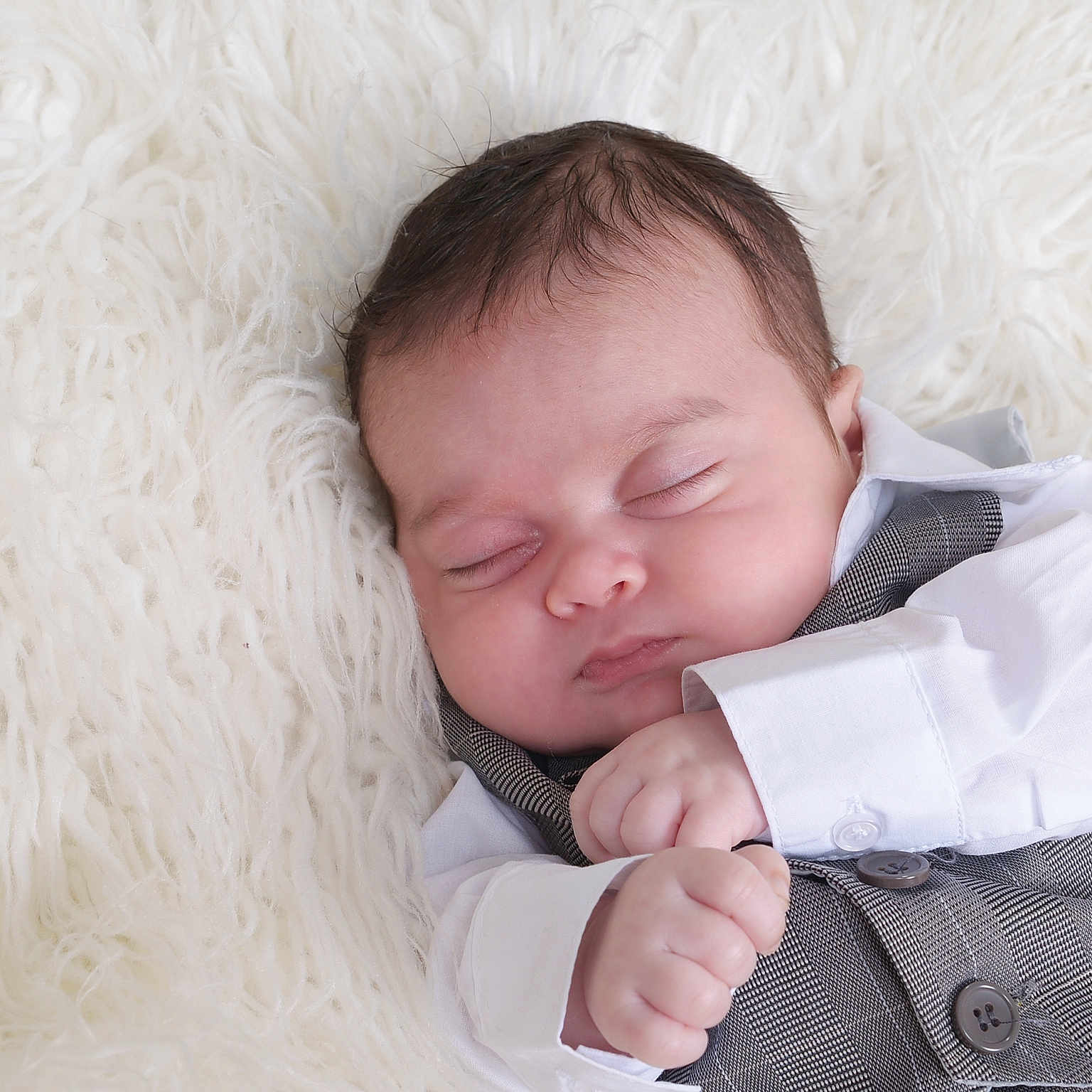 Adrian is registered to the contest to win money with this photo: accessories, baby, bodypart, bonnet, clothing, face, finger, formalwear, frown, hand, hat, head, newborn, person, photography, portrait, sad, shirt, sleeping, tie