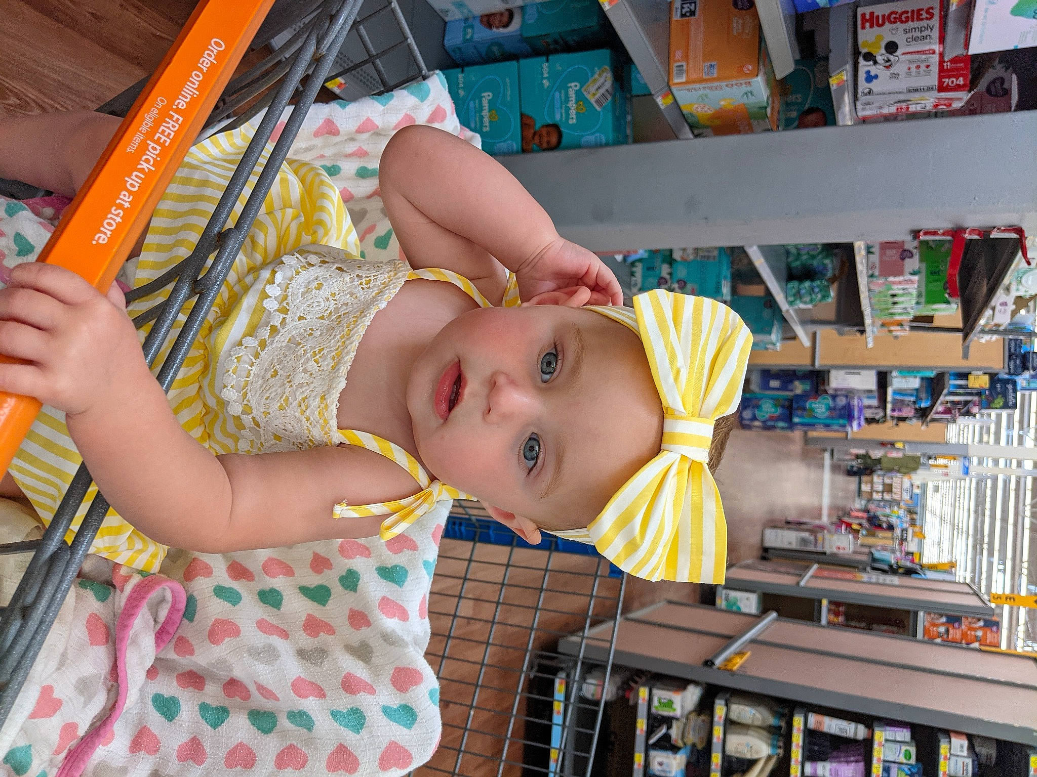 Sophie joined the competition — help win amazing prizes! baby, baby_products, baby_toddler_clothing, bookcase, cheek, child, chin, eye, fun, happy, headwear, human_body, joy, leisure, person, publication, shelf, shelving, skin, smile