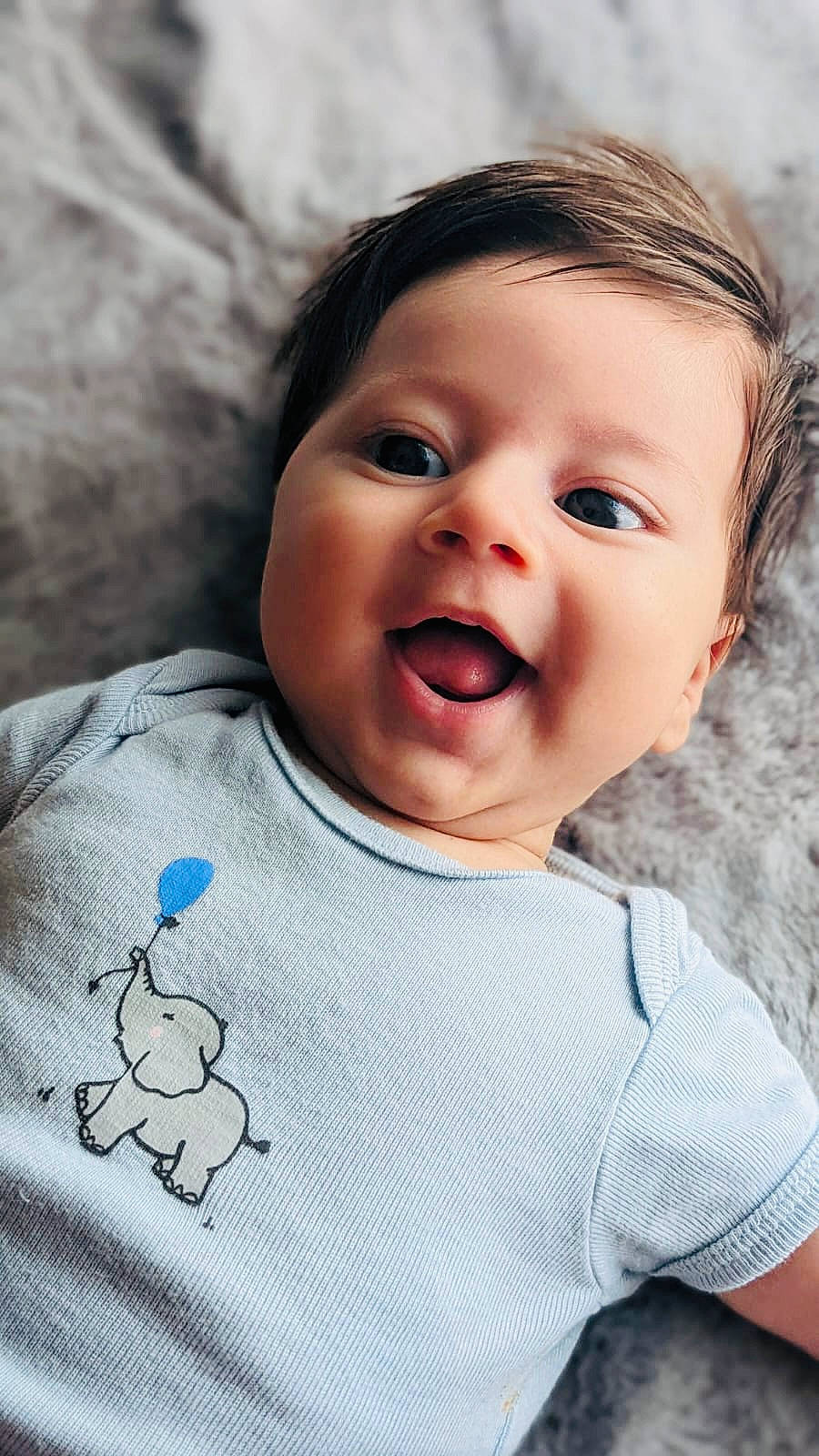 Ely participe au concours pour gagner de l'argent avec cette photo : arm, baby, baby_toddler_clothing, cheek, chin, eye, flash_photography, gesture, hair, happy, iris, lip, mouth, neck, nose, outerwear, person, skin, sleeve, smile