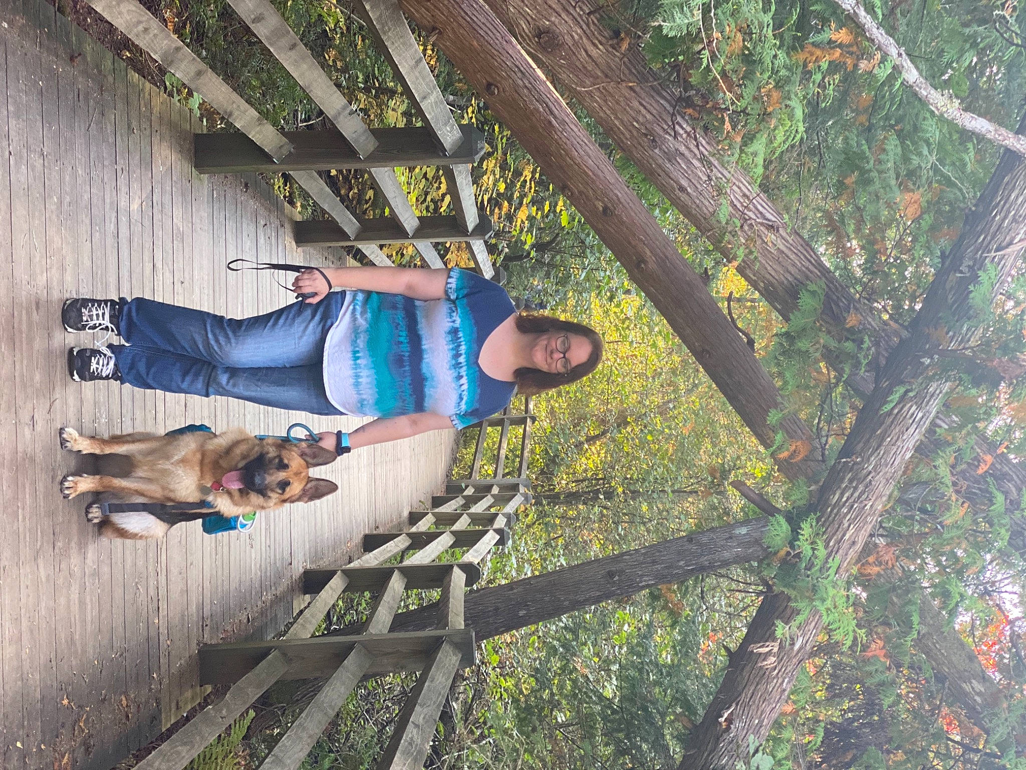 Ellie Blue is registered to the contest to win money with this photo: carnivore, companion_dog, dog, dog_breed, forest, fun, grass, jungle, landscape, leisure, plant, recreation, sitting, smile, t_shirt, tree, wood, woody_plant