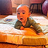 Isaac participe au concours pour gagner de l'argent avec cette photo : baby, child, indoor, floor, quilt, striped_clothing, curious, wide_eyes, pajamas, crawling, furniture, chair, exercise_ball, tile_floor, soft_lighting, person, head, expression, home, cozy