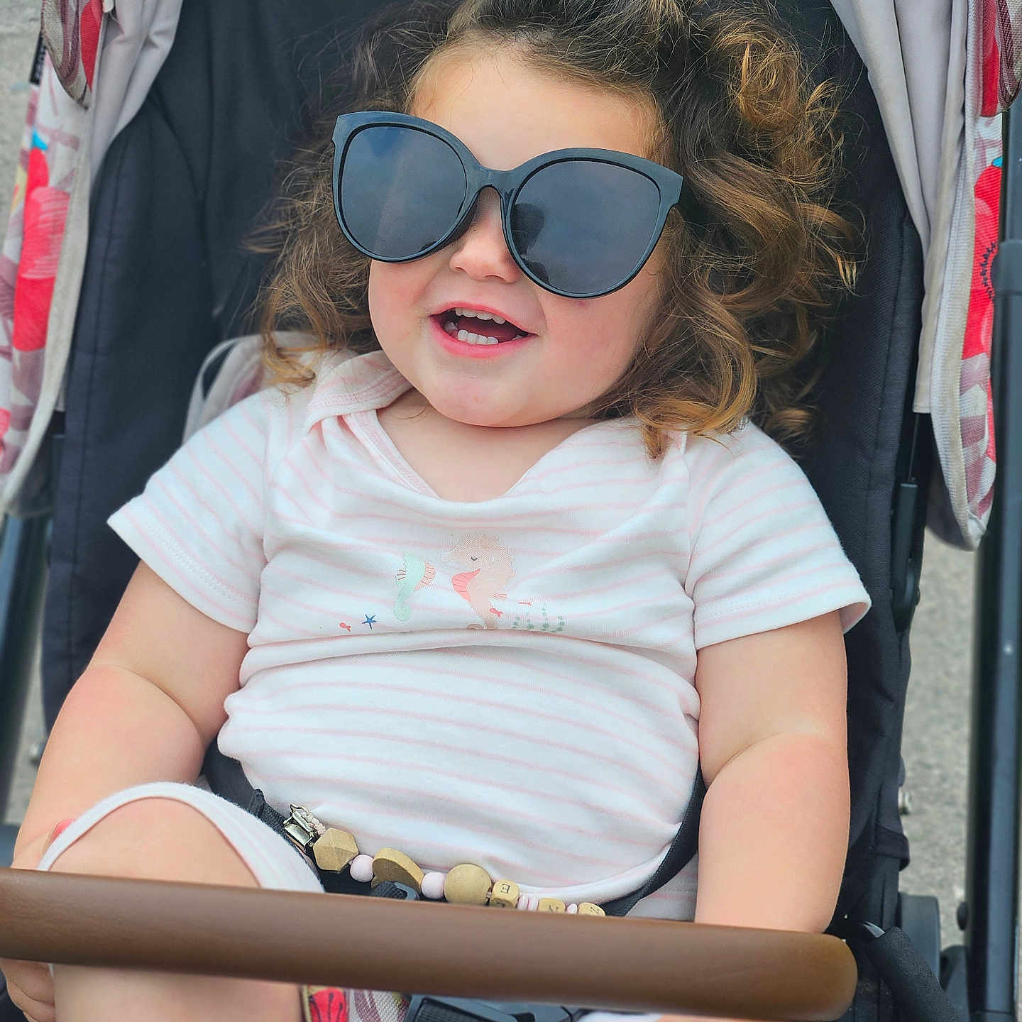 Bonnie joined the competition — help win amazing prizes! accessories, baby, bodypart, clothing, face, footwear, glasses, happy, head, mouth, outdoors, person, photography, portrait, shoe, smile, stroller, sunglasses, t_shirt, teeth