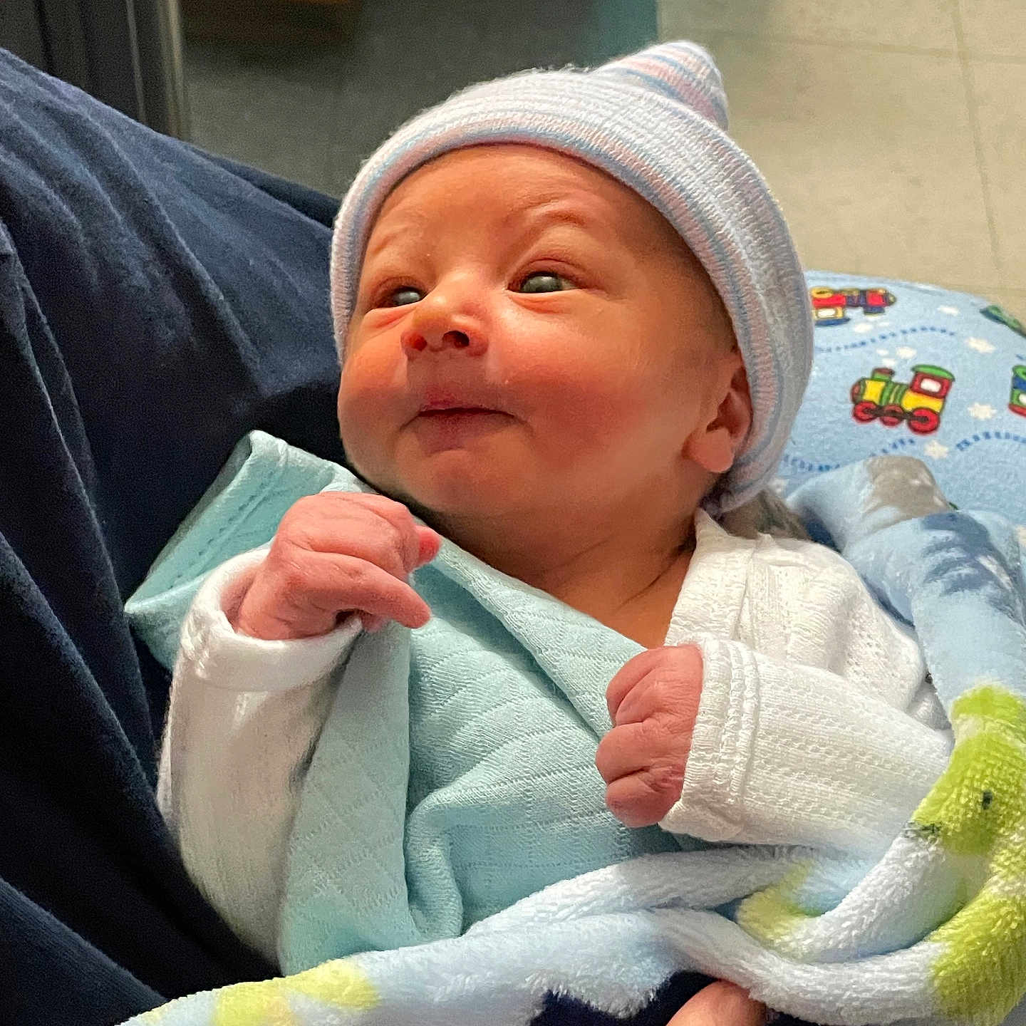 Caysen joined the competition — help win amazing prizes! baby, blanket, child, clothing, cozy, cute, face, hand, hat, holding, indoor, infant, newborn, person, portrait, sleepwear, small, soft, warm, wrapped