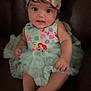 Alaya is registered to the contest to win money with this photo: baby, child, dress, headband, bow, sitting, couch, indoor, cute, infant, person, smile, young, apparel, fabric, portrait, face, hands, foot, leisure