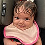 baby, child, smiling, car_seat, bib, hair_bow, red_bow, white_bow, infant, cute, face, hand, seatbelt, closeup, adorable, portrait, skin, clothing, happy, indoor