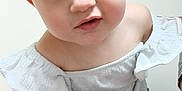 Lainey is registered to the contest to win money with this photo: baby, toddler, child, face, blue_eyes, white_clothing, off_shoulder, cute, curious, portrait, close_up, skin, arm, indoor, person, young_child, human, expression, head, innocence