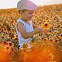 Zak a rejoint le concours — aidez-le/la à gagner de superbes lots ! child, boy, flower_field, sunlight, cap, tank_top, nature, outdoor, smile, happy, yellow_flowers, orange_flowers, sunset, plants, portrait, playing, summer, greenery, warm_light, daytime
