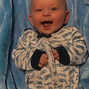 Asher joined the competition — help win amazing prizes! baby, smile, blue_blanket, onesie, infant, happy, child, cute, cozy, patterned_clothing, lying_down, indoor, portrait, face, small_hands, cheerful, soft_texture, warm, expressive, young