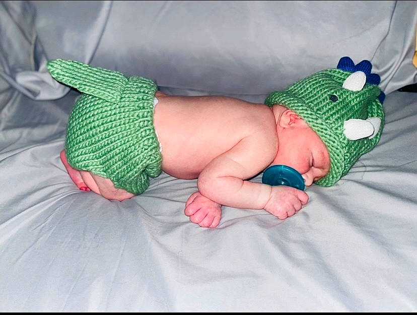 Dakari is registered to the contest to win money with this photo: abdomen, arm, azure, baby, baby_toddler_clothing, barefoot, comfort, diaper, finger, foot, human_body, human_leg, knee, leg, nail, person, sock, textile, thigh, thumb