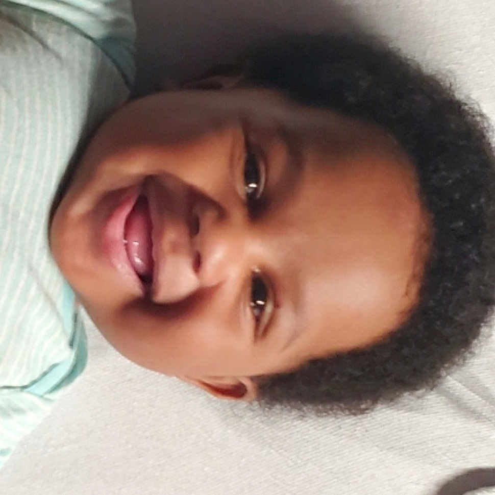 Jae'Cion is registered to the contest to win money with this photo: baby, black_hair, cheek, child, chin, close_up, ear, eye, eyebrow, eyelash, face, forehead, head, jaw, lip, mouth, nose, skin, smile, toddler
