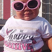 Honesty joined the competition — help win amazing prizes! baby, child, sunglasses, pink, shirt, text, outdoor, building, sunlight, smile, cute, person, infant, fashion, casual, happy, positive, butterfly, clothing, portrait