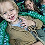 Tiago a rejoint le concours — aidez-le/la à gagner de superbes lots ! casual, casual_clothing, child, crowd, event, family, fun, green, happy, indoor, jacket, people, portrait, scarf, seats, smiling, spectators, sports_fan, stadium, toddler