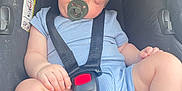 Tiago participe au concours pour gagner de l'argent avec cette photo : accessories, baby, belt, clothing, face, footwear, head, jeans, pants, person, photography, portrait, shoe, shorts, sitting, sleeping, strap, t_shirt, transportation, vehicle