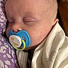 William is registered to the contest to win money with this photo: baby, sleeping, pacifier, blue, giraffe, blanket, closeup, infant, face, peaceful, soft, purple, white, child, newborn, cute, resting, indoors, person, cozy